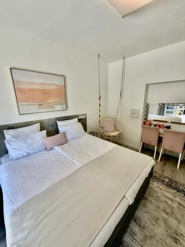 a bedroom with a large white bed in a room at Room TARA Malinska in Malinska