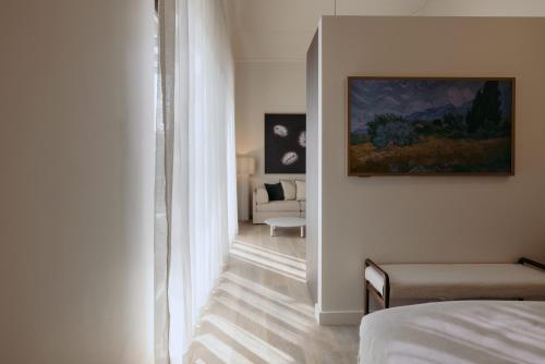 a bedroom with a bed and a room with a couch at Sola Studios in Margaret River Town