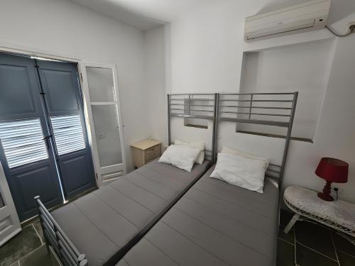 two bunk beds in a room with a window at Villa Thalassa - Vathy in Sifnos