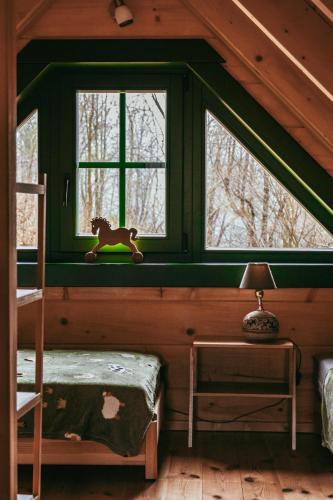 a room with a window with a toy horse on a shelf at Tu W Dolinie in Ropica Górna
