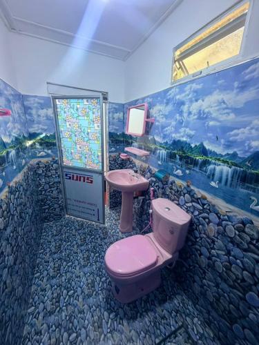 a bathroom with a pink toilet and a sink at QUEEN SASTINA guest house in Nilaveli