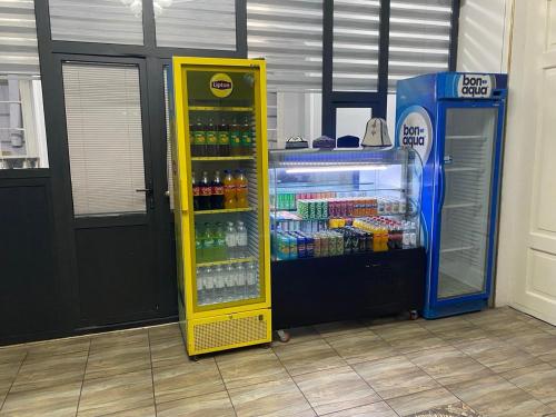 a drink cooler next to a gas pump at Shodlik Hostel in Andizhan