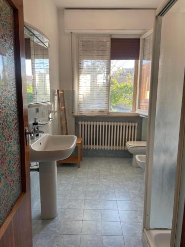a bathroom with a sink and a toilet at Casa vacanza Dominga in Marotta
