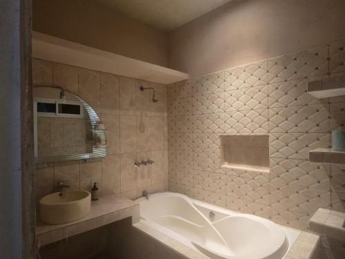 a bathroom with a large tub and a sink at Casa Vidalta in San Sebastián