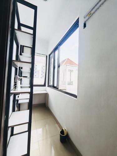 a room with a ladder next to a window at Flo's Transit Home in Manado