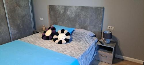 a stuffed animal is laying on a bed at AndyRa in Agigea