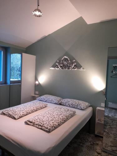 a bedroom with a large bed with white sheets at Home Lotus Flower in Labin