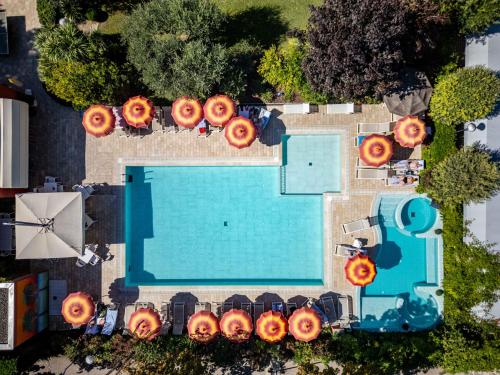 an overhead view of a swimming pool with orange pumpkins on it at Hotel Ariston in Bibione