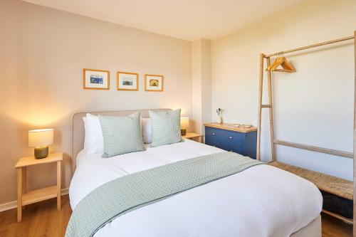 a bedroom with a large white bed and a window at Host & Stay - Stille House in Beadnell
