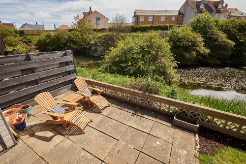two chairs and a table on a patio at Host & Stay - Stille House in Beadnell