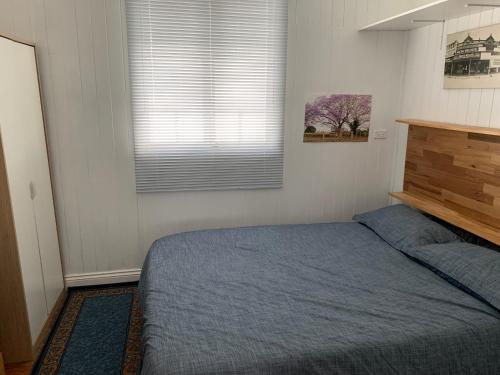 a bedroom with a bed and a window at Kinnoull in Brisbane
