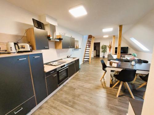 a kitchen with a table and a dining room at FeWo Mäusehaus ID 16291-7 in Kargow