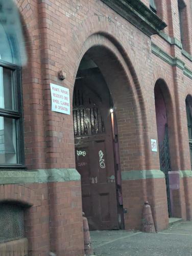an entrance to a brick building with a brown door at Cosy Centre in Dundee