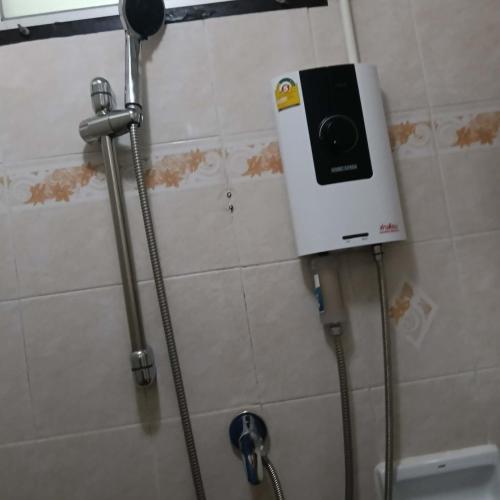 a soap dispenser on the wall of a bathroom at Viriyapon in Bangkok