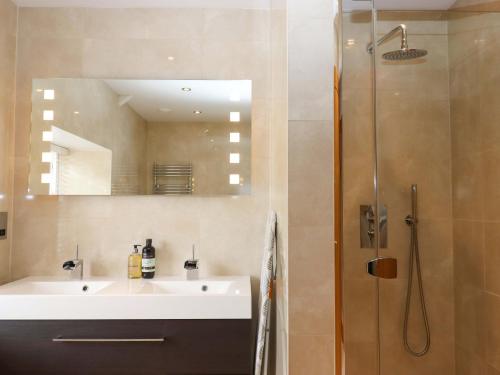 a bathroom with a sink and a shower at Duke's Barn in Totnes