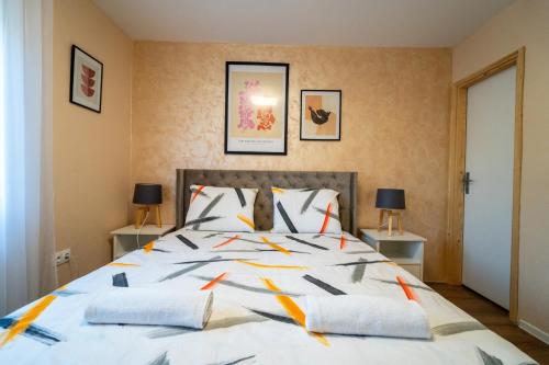 a bedroom with a large bed with two tables at Villa Bella in Mostar