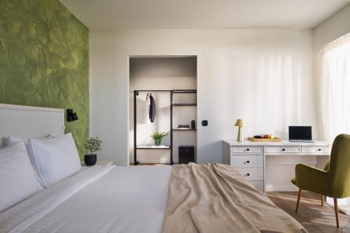 a bedroom with a bed and a desk and a chair at Civitel Attik Rooms & Suites in Athens
