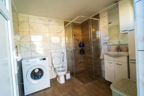 a bathroom with a washing machine and a shower at Villa Bella in Mostar