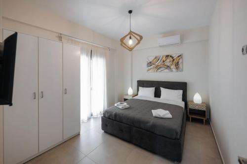 a bedroom with a bed and a tv in it at Soro Rooms in Kanali