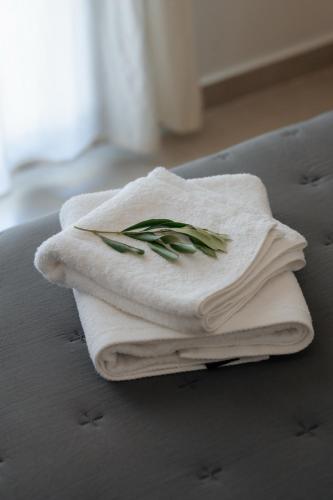 a pile of towels sitting on top of a bed at Soro Rooms in Kanali