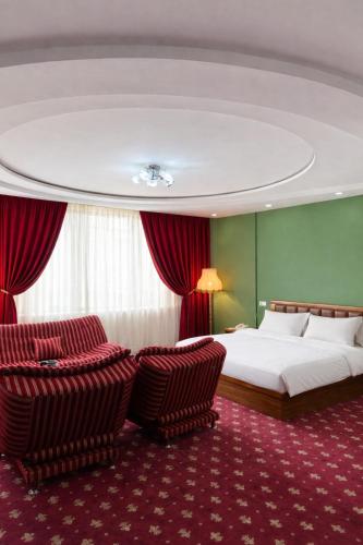 a hotel room with a bed and two chairs at Gyumri Hotel in Gyumri