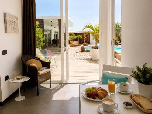 a room with a table with a plate of food on it at Villa Claus - Private Pool Oasis in Puerto Calero in Puerto Calero