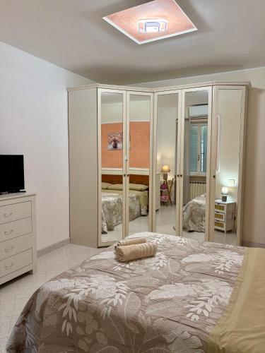a bedroom with a large bed and a television at Demetra Apartment Sperlonga in Sperlonga