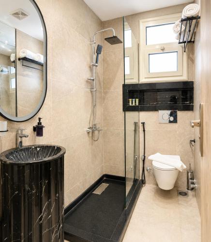 a bathroom with a glass shower and a toilet at Stay Inn 51 Hotel Zayed in Sheikh Zayed