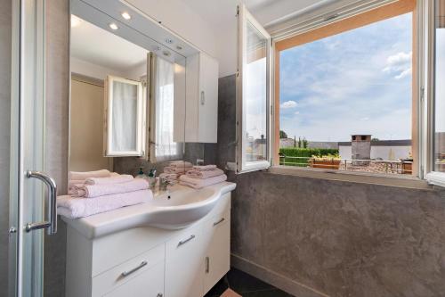 a bathroom with a sink and a large window at La Casa Di Lillo - Angera in Angera