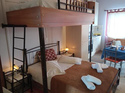 a bedroom with a bunk bed with two pairs ofippers at Giannad suite in Distomo