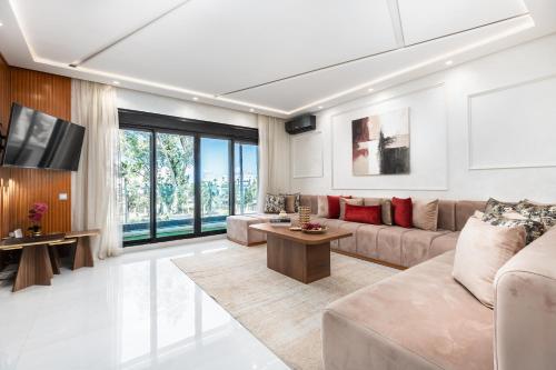 a living room with a couch and a table at Seaside Pool View 3BR Apt with 2 Balconies in Tangier