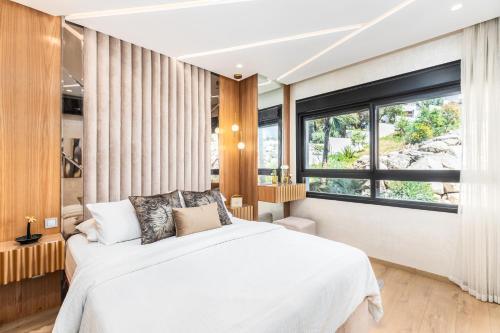 a bedroom with a bed and a large window at Seaside Pool View 3BR Apt with 2 Balconies in Tangier