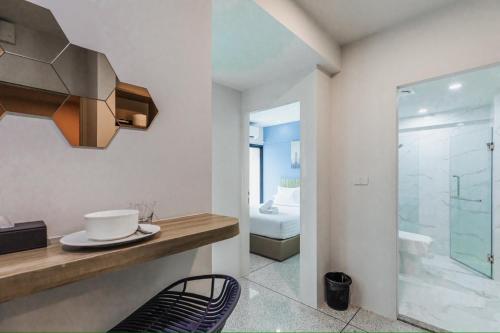a bathroom with a sink and a glass shower at ABC@48 Hotel & Service Apartment in Bangkok