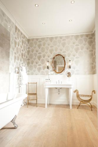 a bathroom with a sink and a mirror at Ormesby Manor House & The Shepherds Huts & Well Lodge in Ormesby Saint Michael