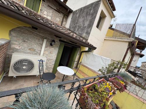 a balcony with a table and a fan at Ca'del Porto in Marano Lagunare