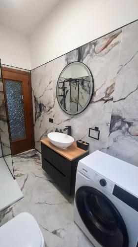 a bathroom with a sink and a washing machine at Casa Katarina Beach Apartment in Silvi Marina