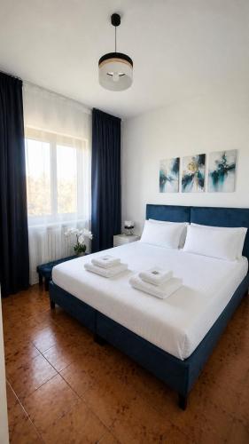 a bedroom with a large bed with a blue headboard at Casa Katarina Beach Apartment in Silvi Marina