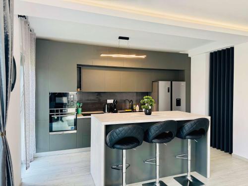 a kitchen with a counter with stools at a bar at Joy City Stay Lavandei 2 in Timişoara