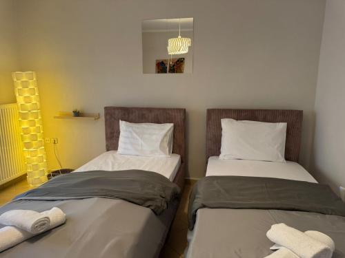 two beds sitting next to each other in a room at Krithia Apartment with Garden Family Apartment in Krithiá