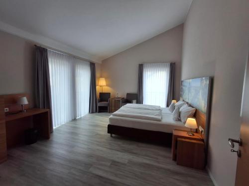 a hotel room with a bed and a window at Linden's Pension-Restaurant in Ayl