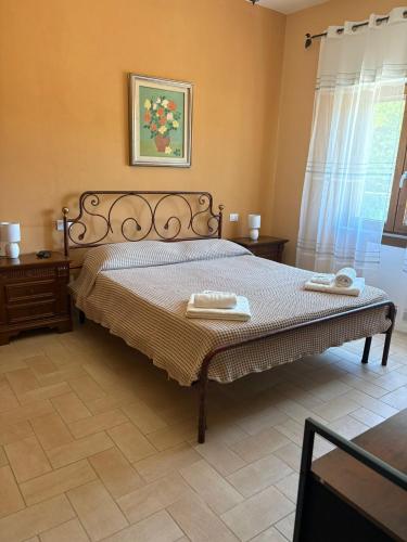 a bedroom with a bed with two towels on it at B&B Ducato delle Seimiglia in Camaiore
