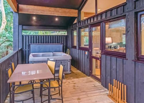 a tiny house with a table and a bed at Brockwood Hall Lodges in Silecroft