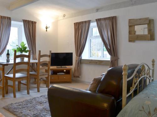 a living room with a couch and a dining room at Kingfisher Apt - B4866 in Liskeard