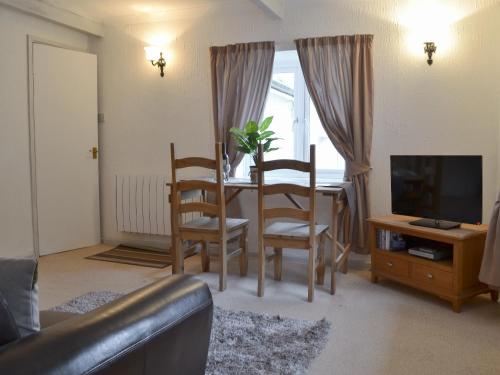 a living room with a table and chairs and a television at Kingfisher Apt - B4866 in Liskeard