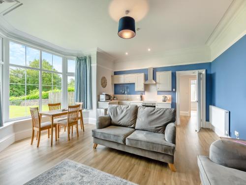 a living room with a couch and a table at Silverdale Apartment in Lindale