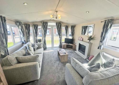 a living room with two couches and a tv at Aldbrough Leisure Park in Aldbrough