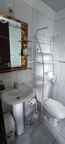 a bathroom with a sink and a toilet and a mirror at Edificio Paradisíaco,Cochabamba in Cochabamba