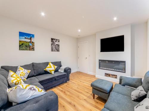 a living room with two couches and a tv at The Bunker - Uk47763 in Bamburgh