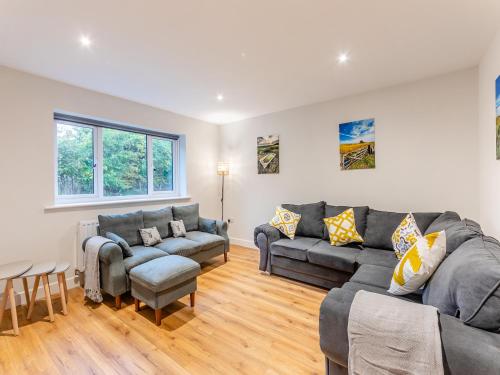 a living room with two couches and a table at The Bunker - Uk47763 in Bamburgh