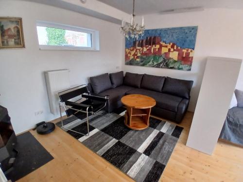 a living room with a couch and a table at Wein4tel Auszeit in Blumenthal